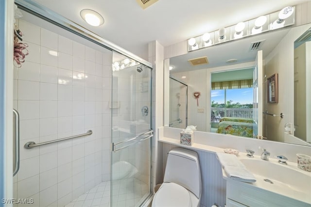 bathroom with vanity, an enclosed shower, and toilet