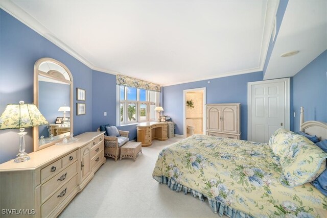 carpeted bedroom with ornamental molding and a closet