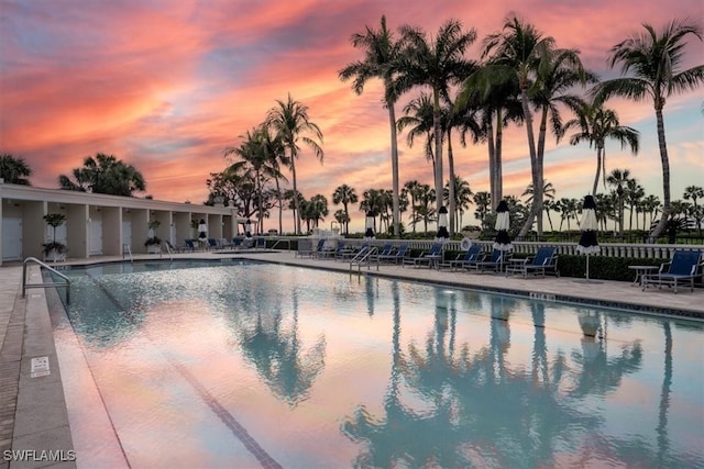 pool at dusk featuring a patio