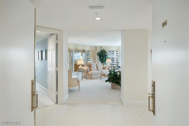 corridor featuring light colored carpet