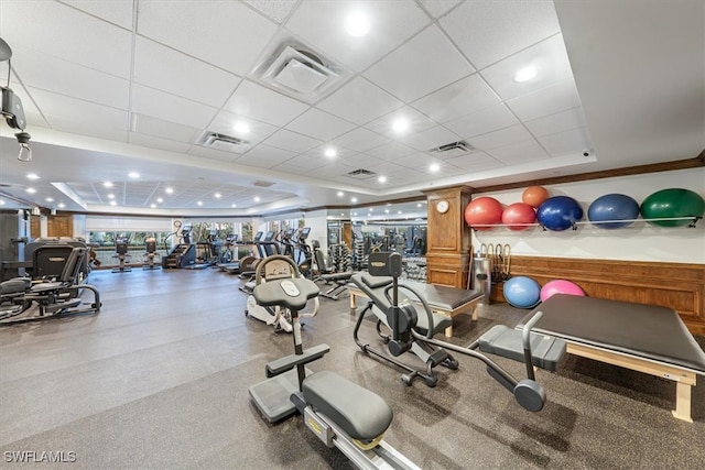 workout area with crown molding and a paneled ceiling