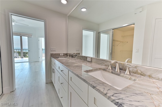 bathroom with vanity, hardwood / wood-style flooring, and ceiling fan