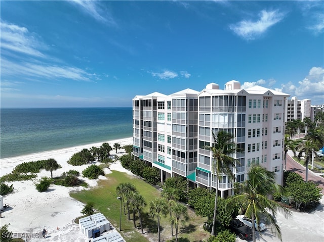 view of building exterior featuring a view of the beach and a water view