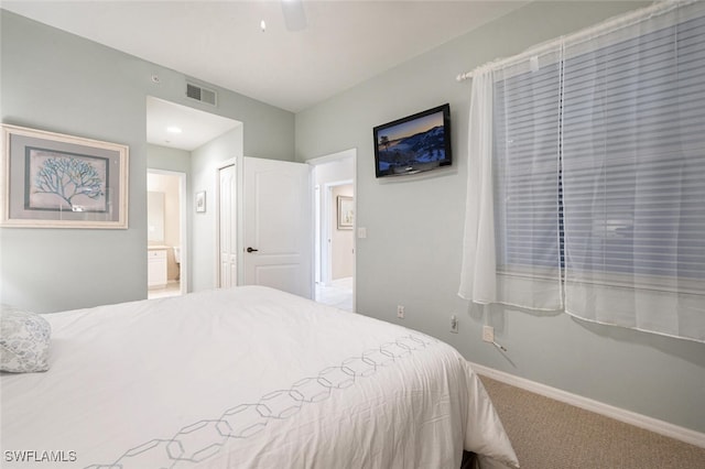 carpeted bedroom with ceiling fan, ensuite bathroom, and a closet