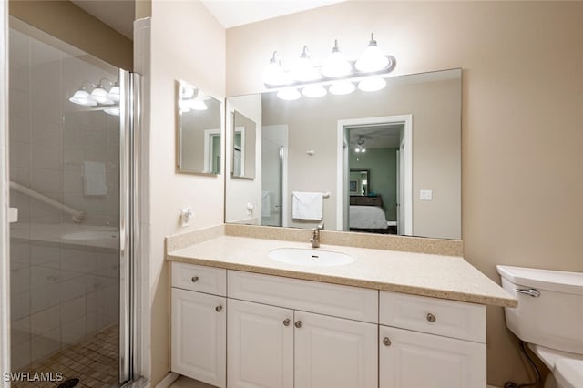 bathroom featuring walk in shower, vanity, and toilet