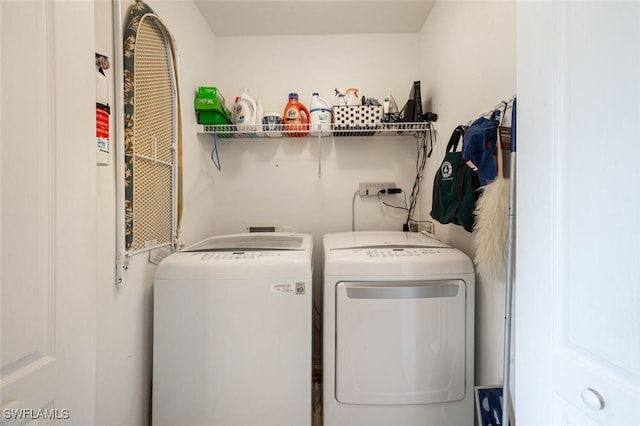 washroom with washing machine and clothes dryer