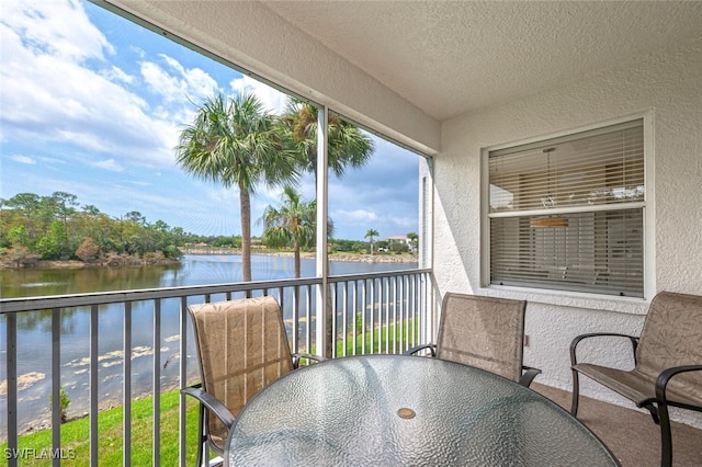 sunroom / solarium with a water view