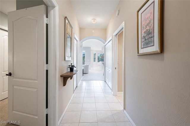 corridor with light tile patterned floors