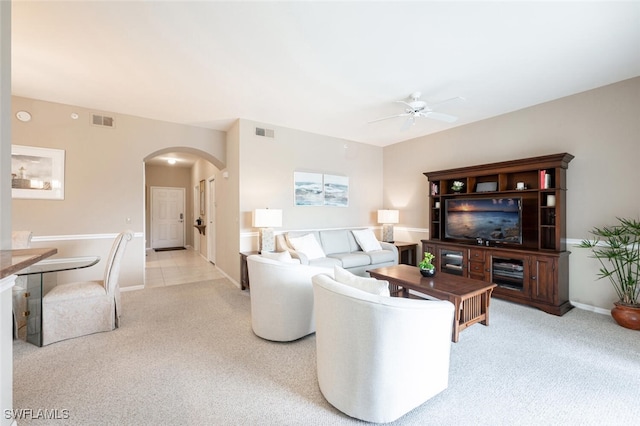 living room with ceiling fan and light colored carpet