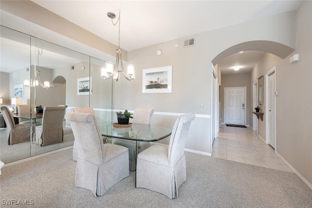 dining area featuring light carpet