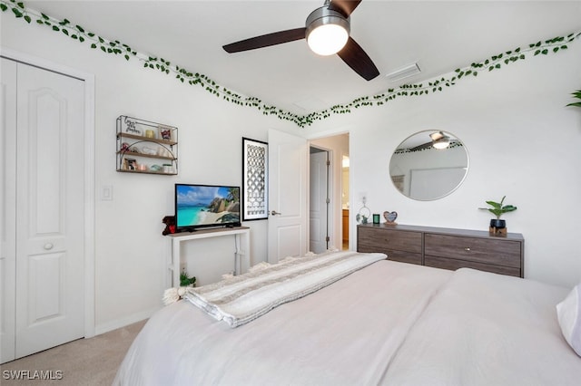 bedroom with a ceiling fan, visible vents, and light colored carpet