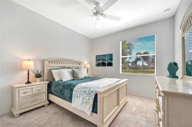 bedroom featuring light colored carpet, ceiling fan, and baseboards