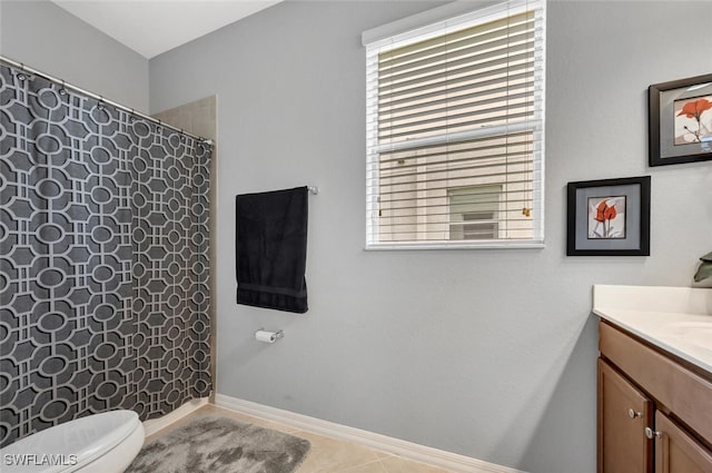 full bath featuring toilet, vanity, a shower with curtain, baseboards, and tile patterned floors