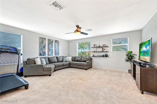 living room featuring light carpet, a wealth of natural light, and ceiling fan