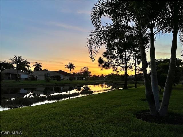 yard at dusk with a water view