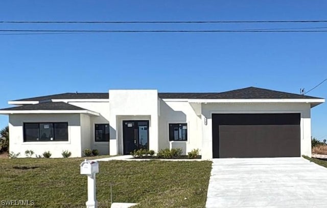 view of front facade featuring a front yard and a garage