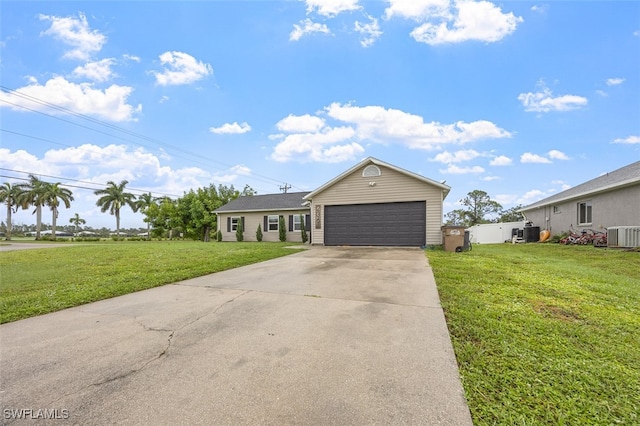 view of front of house featuring a garage, a front lawn, and central air condition unit