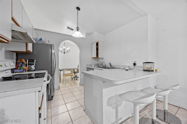 kitchen with light tile patterned flooring, white cabinets, kitchen peninsula, white electric range oven, and pendant lighting