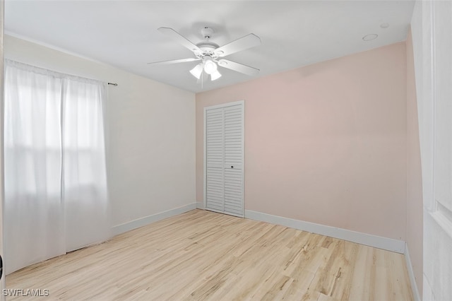 unfurnished room with light wood-type flooring and ceiling fan