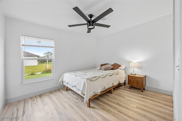 bedroom with light hardwood / wood-style floors and ceiling fan