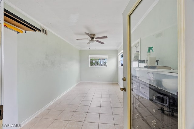 interior space featuring ornamental molding, ceiling fan, and light tile patterned flooring