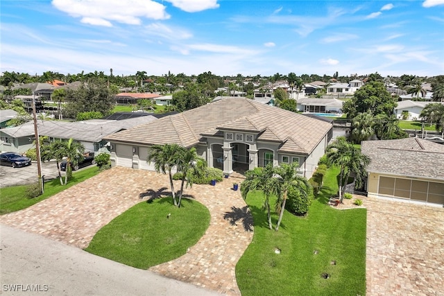 view of front of home with a front lawn and a garage