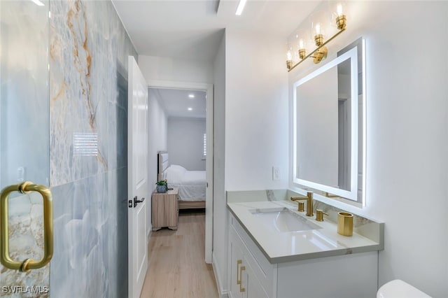 bathroom with hardwood / wood-style flooring and vanity