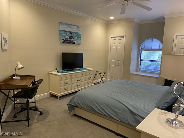 carpeted bedroom featuring ornamental molding, ceiling fan, and a closet