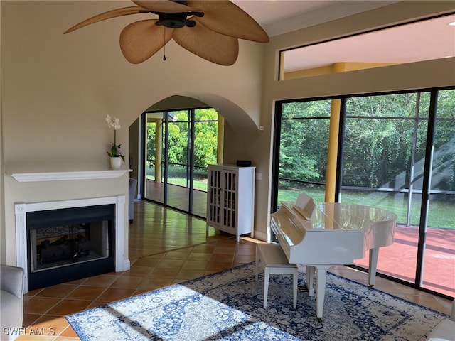 interior space with ornamental molding, ceiling fan, and plenty of natural light