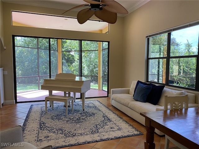 tiled living room with a healthy amount of sunlight, crown molding, and ceiling fan