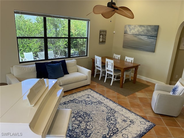 living room featuring ceiling fan and tile patterned floors