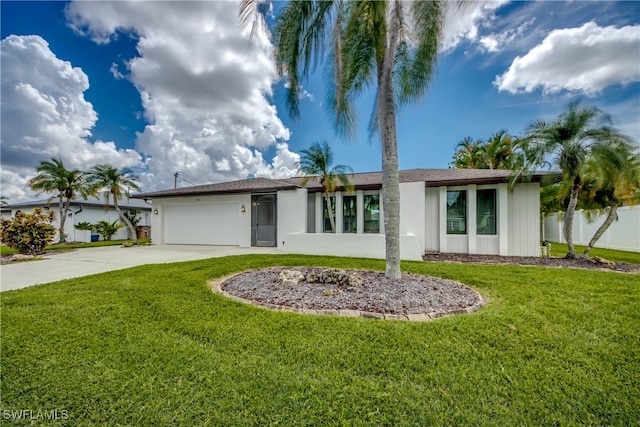 view of front of property with a front yard and a garage