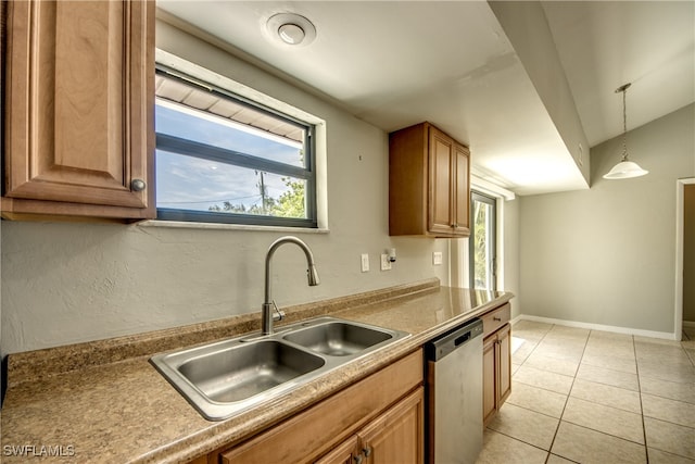 kitchen featuring dishwasher, sink, hanging light fixtures, and light tile patterned floors