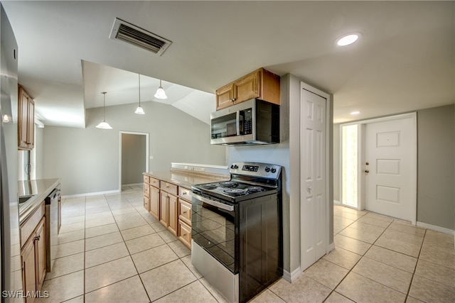 kitchen featuring hanging light fixtures, appliances with stainless steel finishes, light tile patterned floors, and lofted ceiling