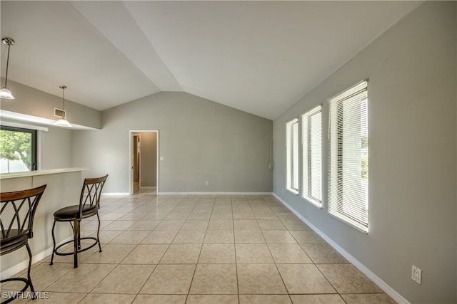 interior space with lofted ceiling and light tile patterned floors