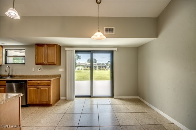 kitchen with sink, decorative light fixtures, light tile patterned floors, and dishwasher