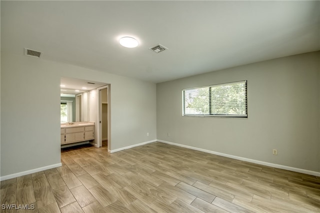 unfurnished bedroom with multiple windows