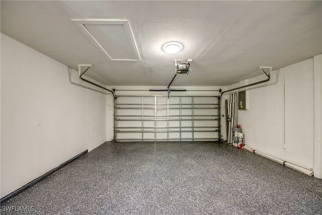 garage with a garage door opener and electric panel