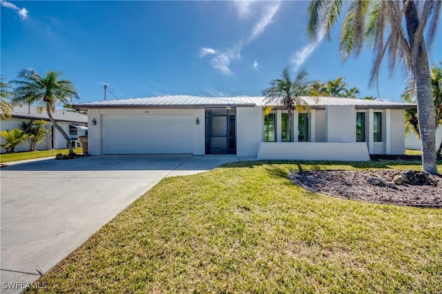 ranch-style house featuring a garage and a front lawn