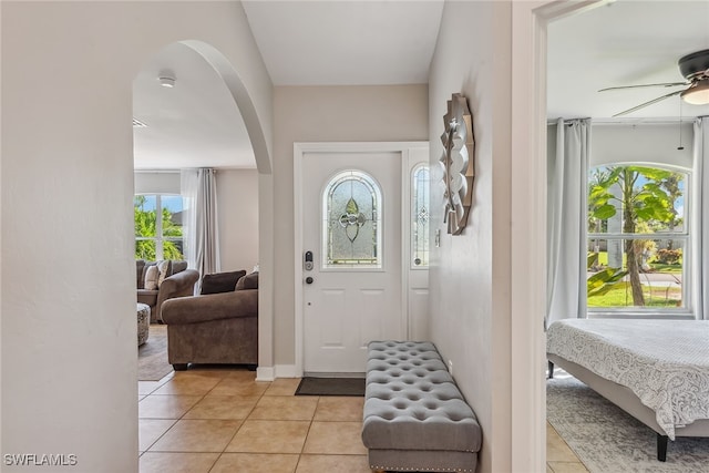 tiled foyer entrance featuring a wealth of natural light and ceiling fan