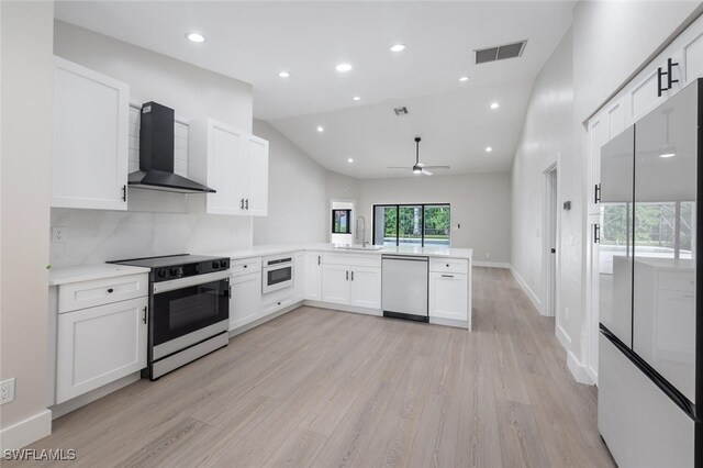 kitchen featuring range with electric cooktop, wall chimney exhaust hood, stainless steel dishwasher, kitchen peninsula, and white cabinets