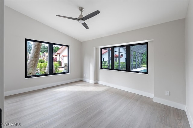 empty room featuring ceiling fan, light hardwood / wood-style floors, and lofted ceiling