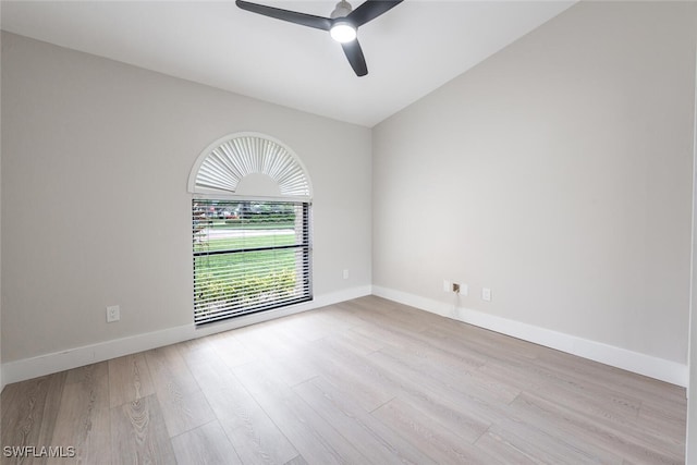 unfurnished room with ceiling fan, light wood-type flooring, and vaulted ceiling