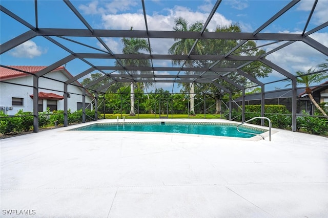 view of pool with a patio and a lanai