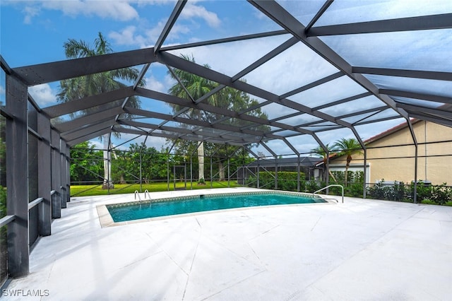 view of swimming pool with glass enclosure and a patio area