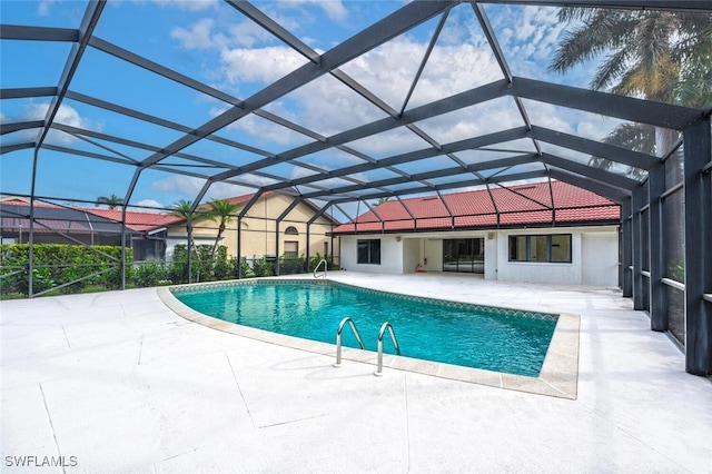 view of swimming pool featuring a patio area and glass enclosure