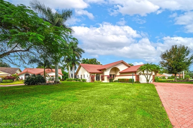 view of front of property with a garage and a front yard