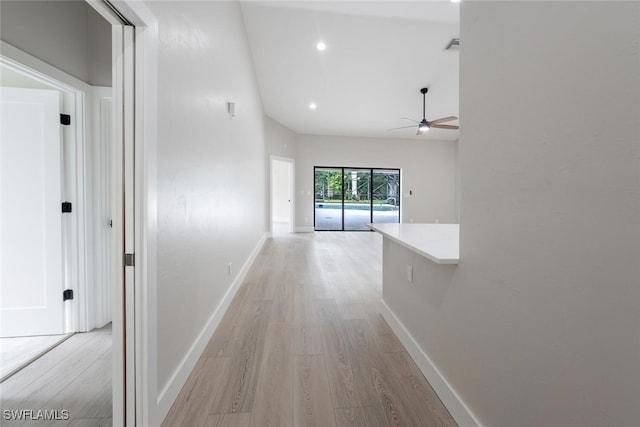 hallway with light hardwood / wood-style floors