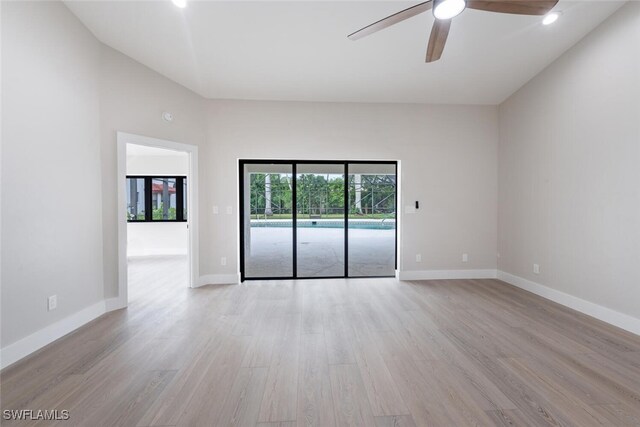 empty room with ceiling fan and light wood-type flooring