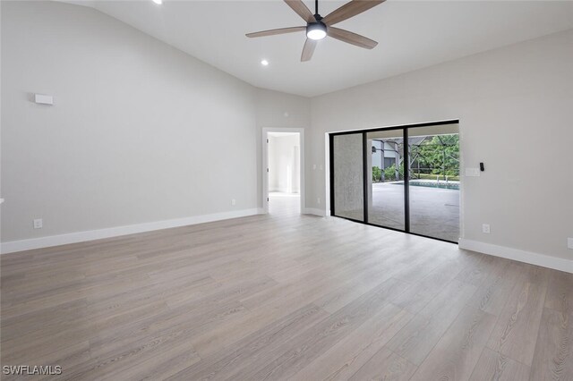 unfurnished room featuring ceiling fan, high vaulted ceiling, and light hardwood / wood-style flooring